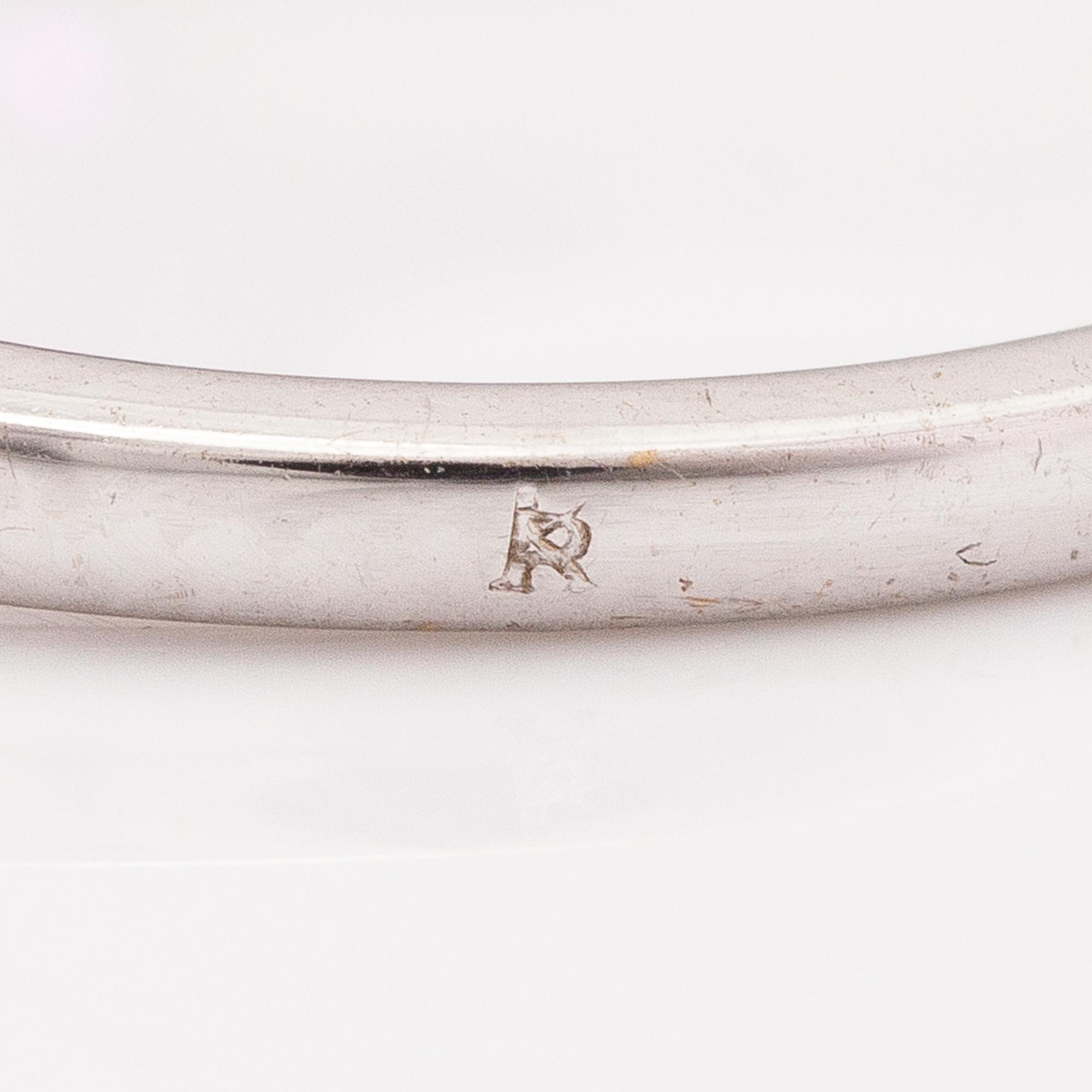 An 18K gold ring with enamel, diamonds ca. o.06 ct in total and a ruby.