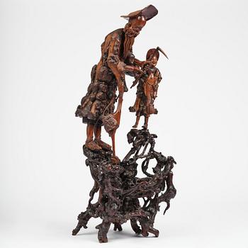A large well sculptured root sculpture of 'Sholau and attendant', late Qing dynasty, 19th century.