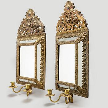 An early 20th Century pair of baroque style mirror sconses.