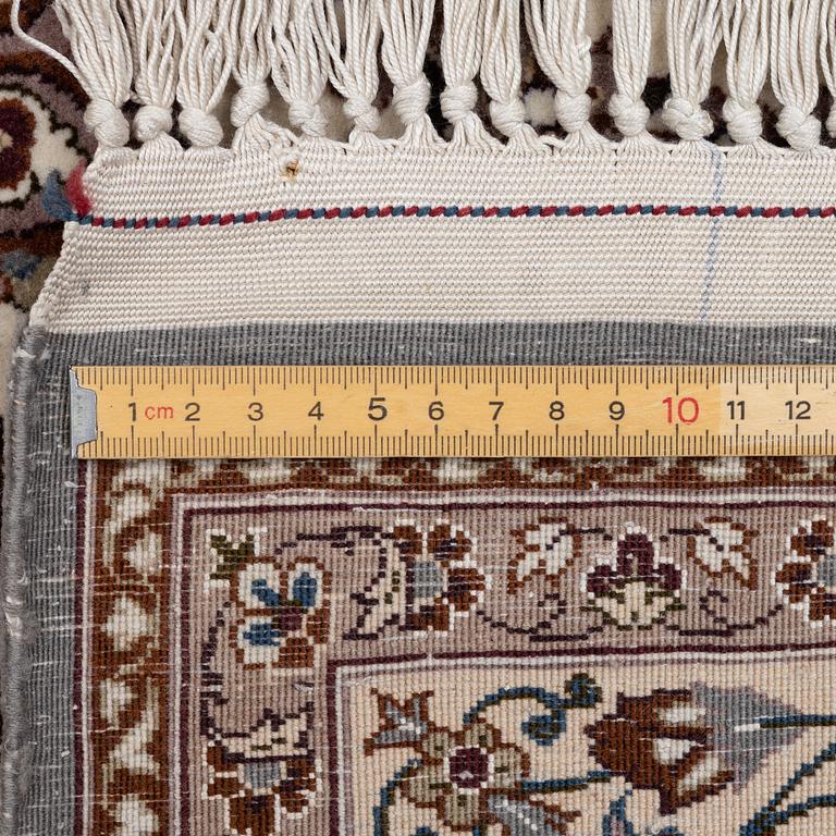 A semi-antique Isfahan rug, central Persia, signed Ghaffarian, c. 180 x 112 cm.