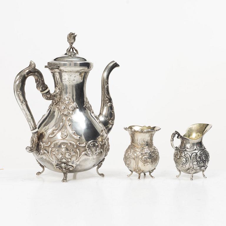 A silver Rococo style coffee pot, creamer and sugar bowl, Swedish import mark of Gewe Silvervarufabriken Ab, Malmö, 1977.