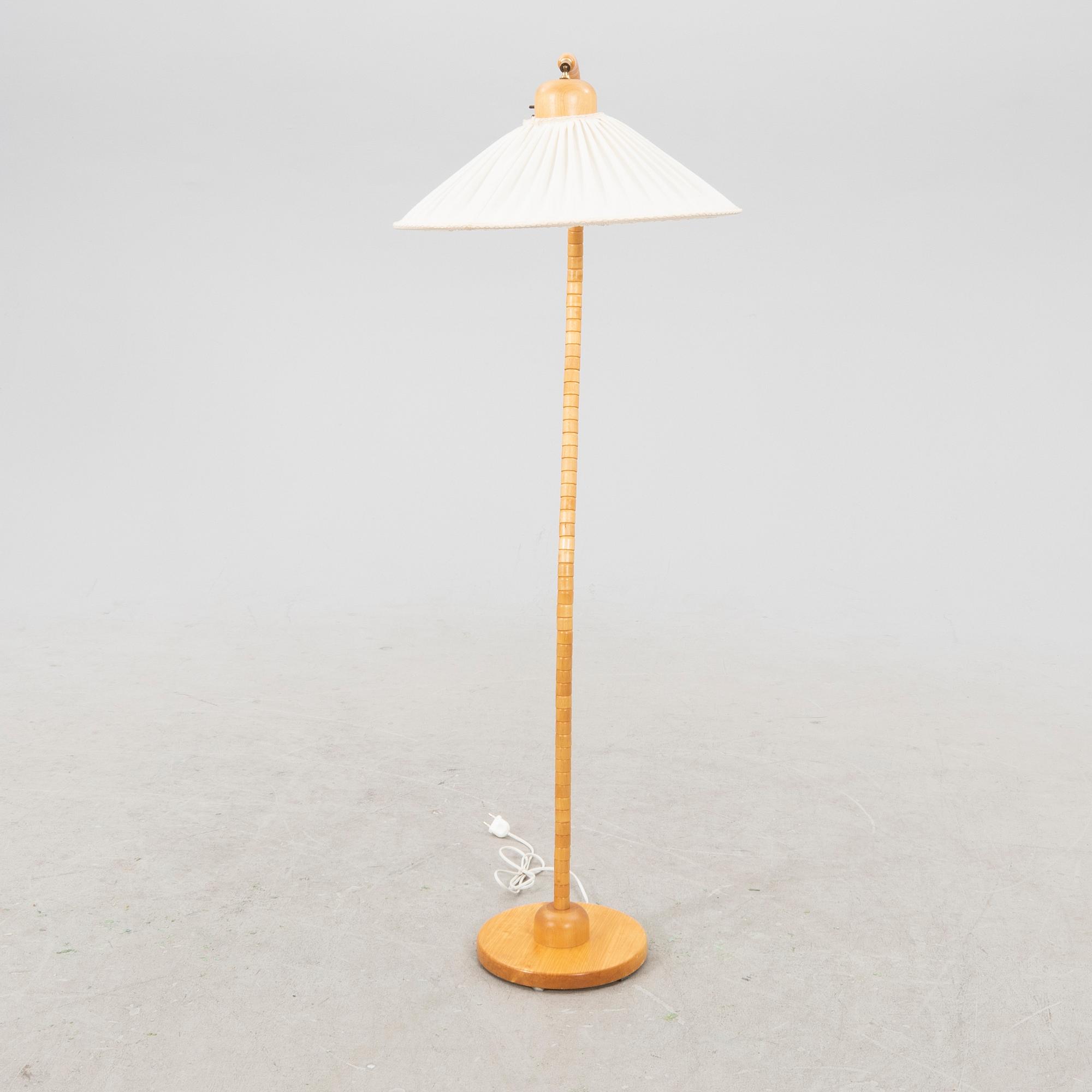 A Markslöjd 21st century wooden floor lamp.
