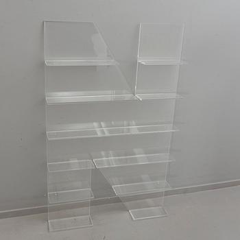 Shelf, plexi glass, in the shape of the letter 'N',Non Violence.