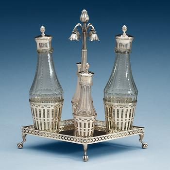 921. BORDSURTOUT, silver, för fyra flaskor, gustaviansk, Johan Wilhelm Zimmerman, Stockholm 1799. Vikt 750 gram.