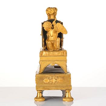 A French Empire sculptural ormolu and patinated bronze mantel clock, early 19th century.