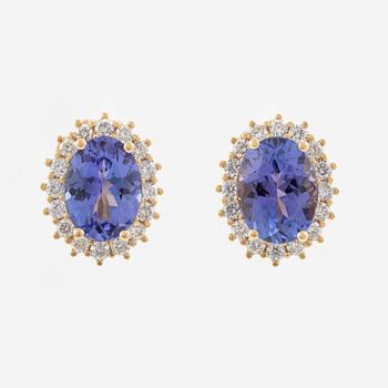 A pair of 18K gold earrings with faceted tanzanites and round brilliant-cut diamonds.