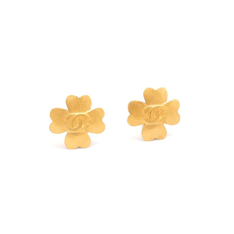 CHANEL, a pair of gold colored flower shaped earclips.