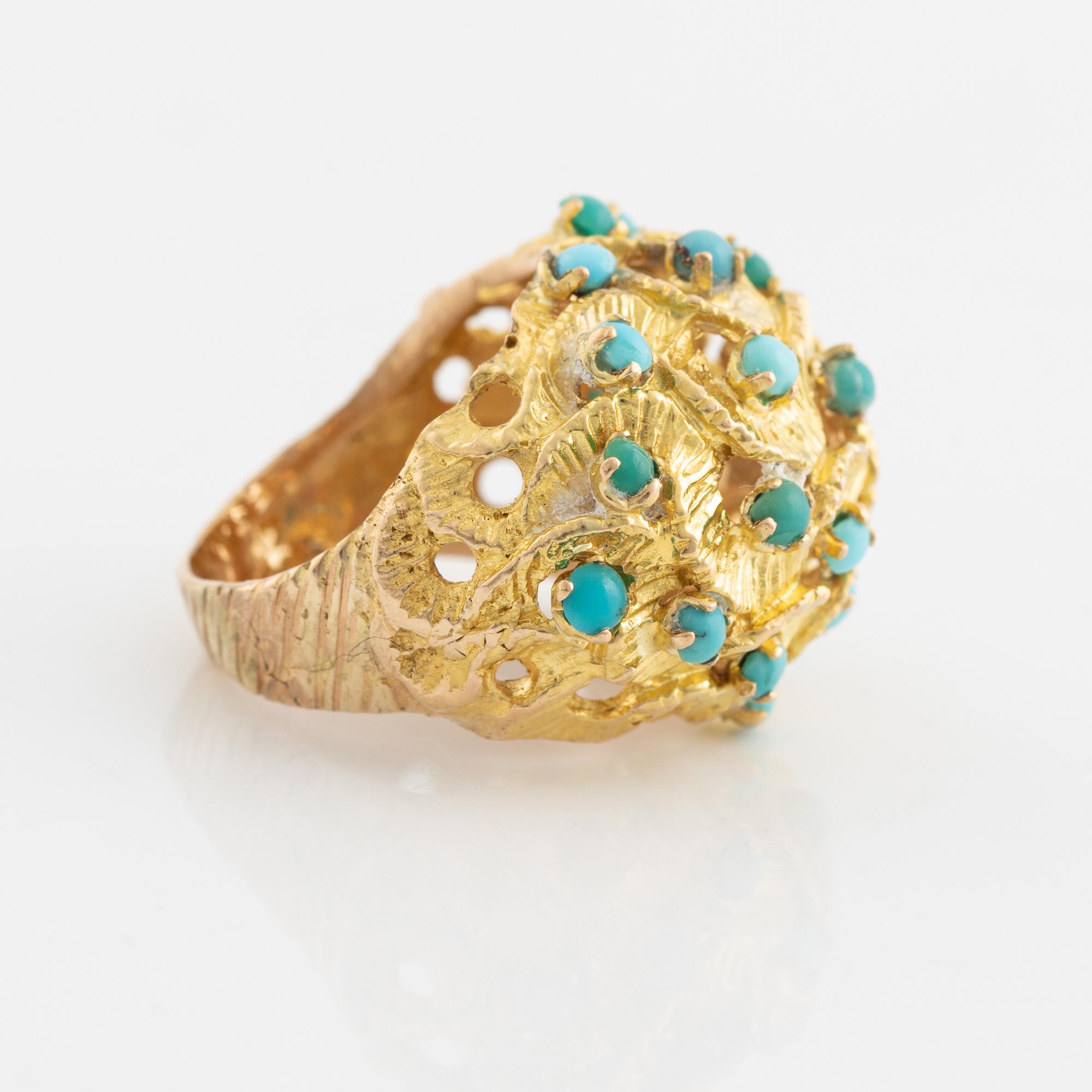 A 14K gold ring set with turquoises.