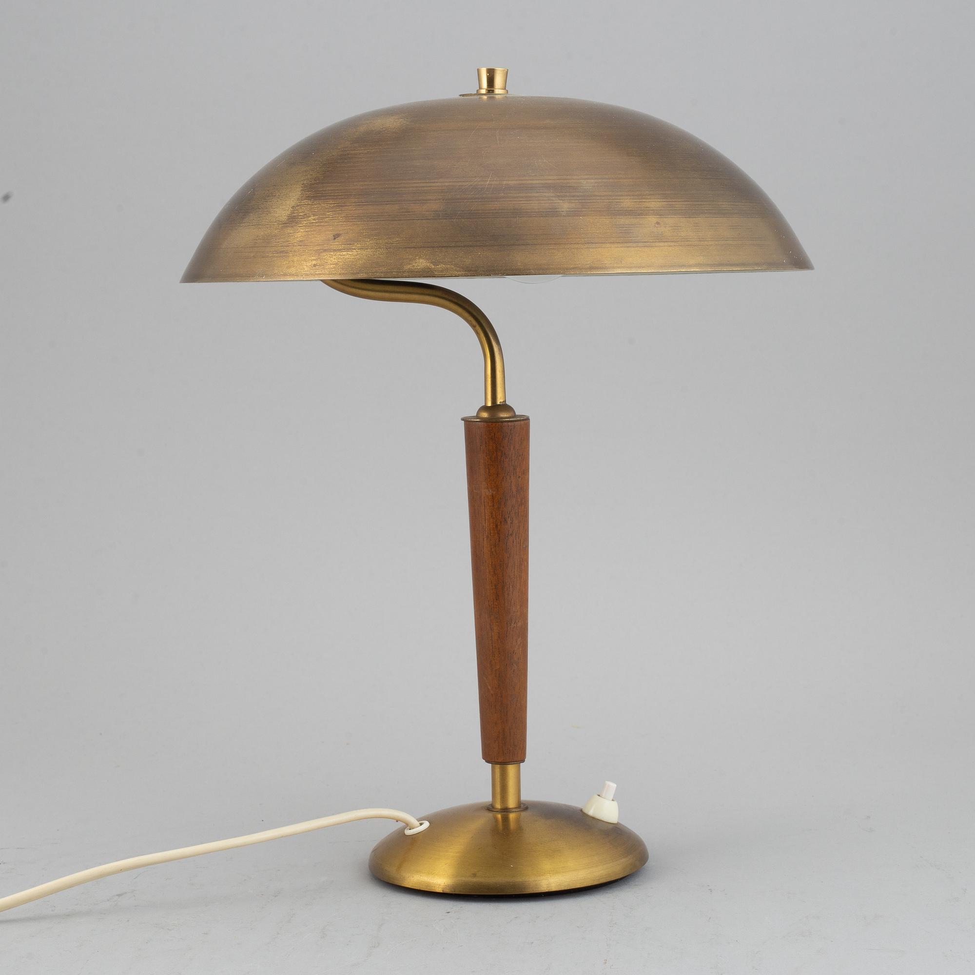 A brass and teak table lamp, 1960's.