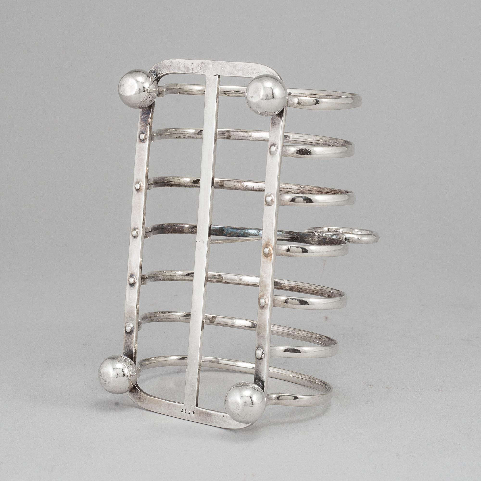 An English 20th century silver-plated toast rack, marked WH.