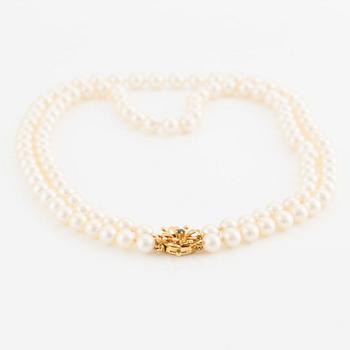 Necklace, double strand of cultured pearls, clasp in 18K gold set with eight-cut diamonds and a sapphire.