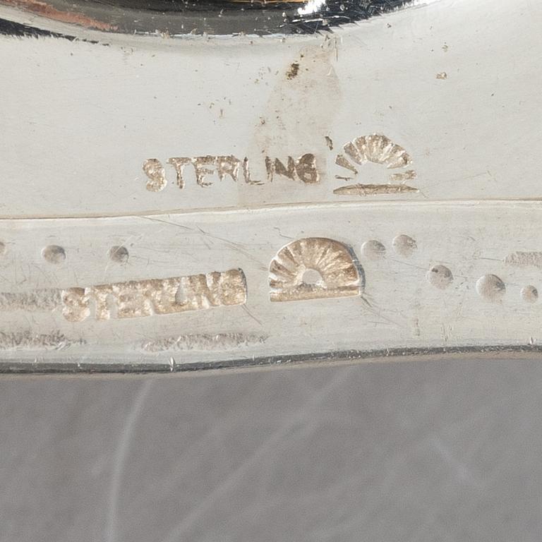 Two sterling silver tea strainers with stands, 20th century.