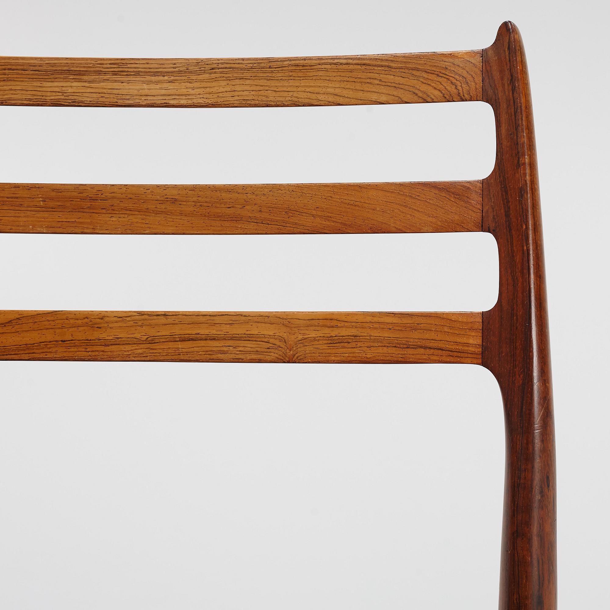 Niles Otto Møller, a rosewood veneered table with four chairs, JL Møller, Denmark, 1950's/60's.