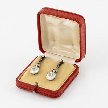 A pair of platinum earrings with two old-cut diamonds.