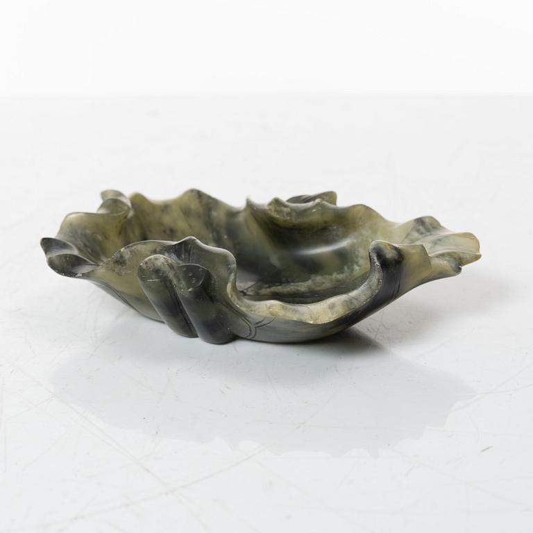 A Chinese green stone brush washer, a carved bone and a soapstone figure, partly Qing dynasty.