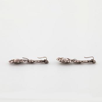 A pair of earrings and a brooch set with rose cut diamonds.