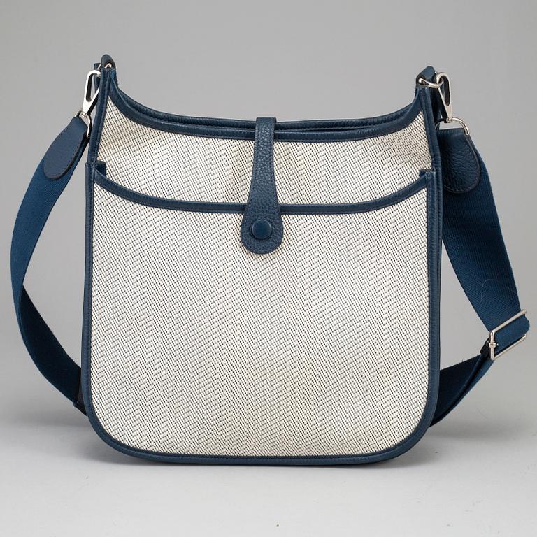 HERMÈS, a canvas and blue leather crossbody bag, "Evelyn".