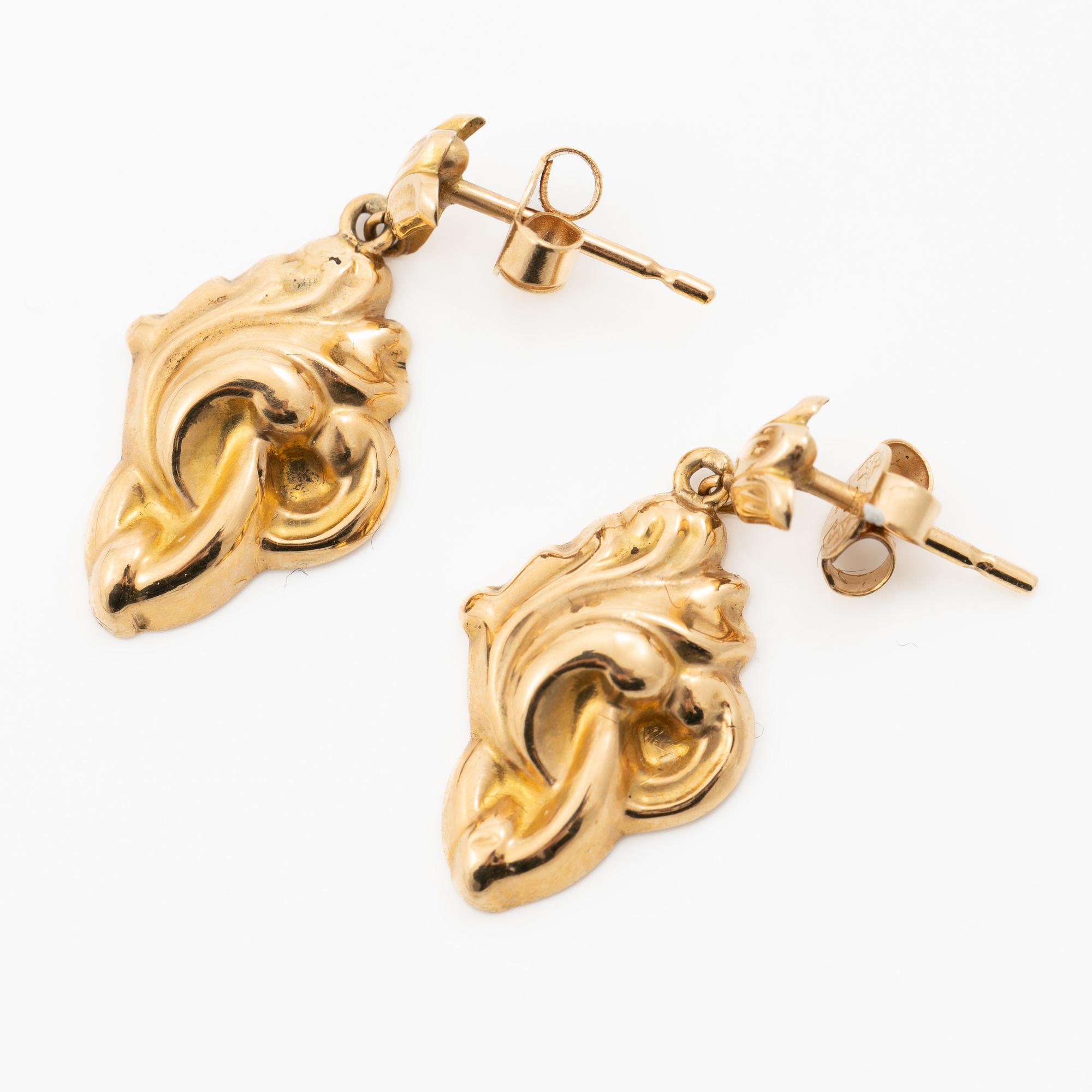 A pair of 18K gold earrings.