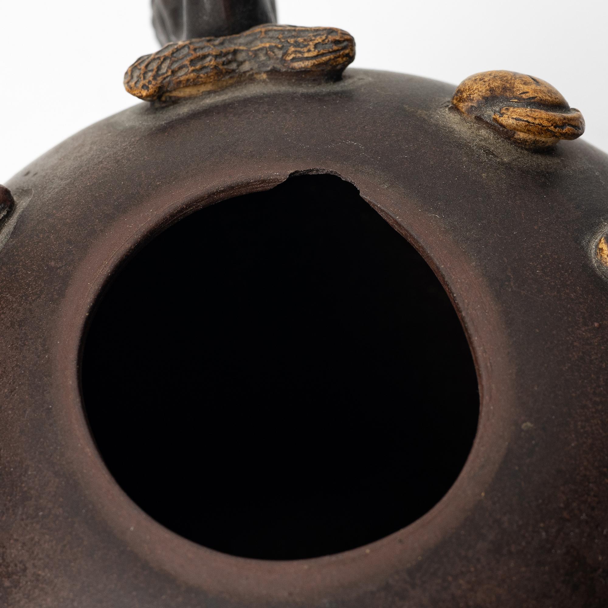 A Chinese 'hundred-fruit' yixing teapot, Qing dynasty (1644-1912).