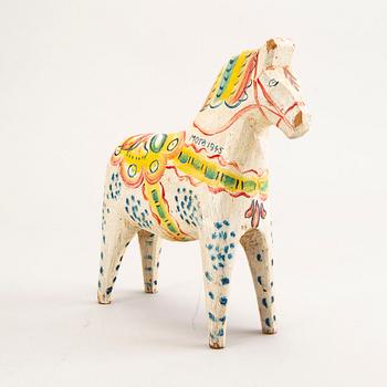 A Swedish painted and dated 1945 wooden horse.