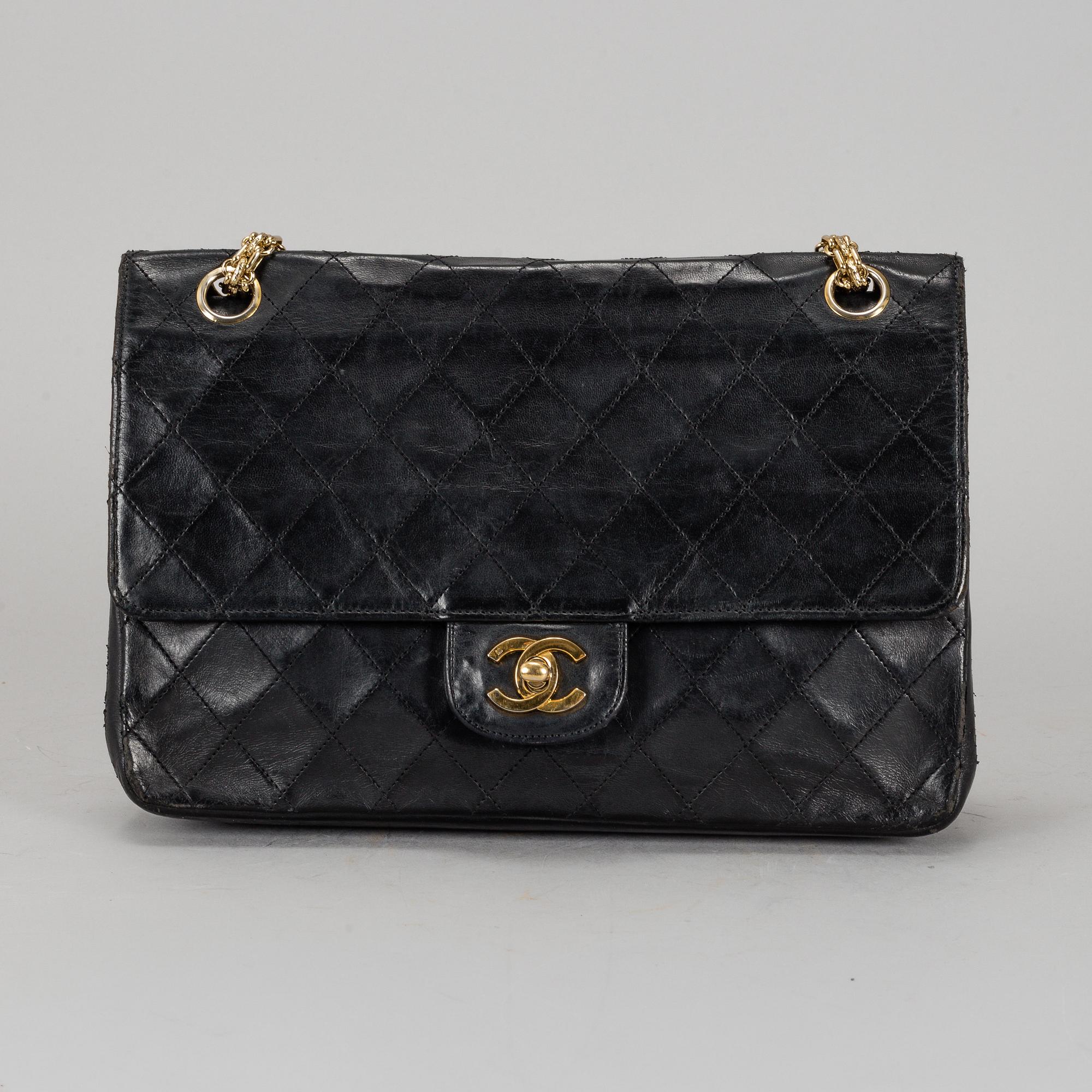 CHANEL, a quilted black leather 'Double Flap Bag'.