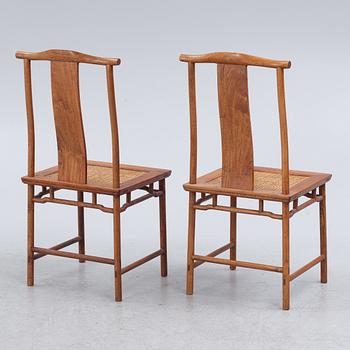 A Chinese hardwood dinner table and ten chairs with rattan seats, 20th century.