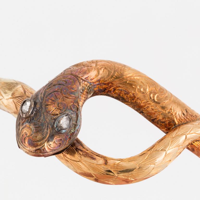 An 18K gold snake bangle with rose-cut diamonds.