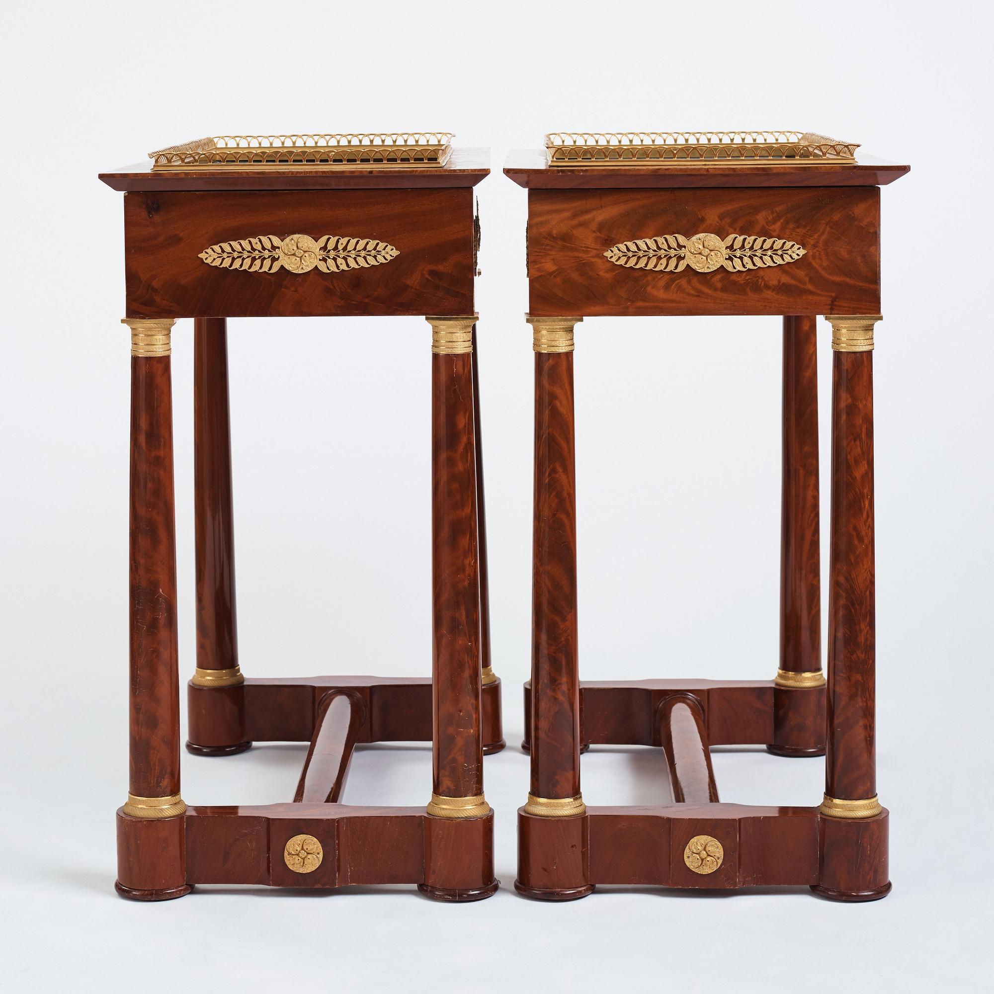 A pair of French Empire gilt bronze-mounted mahogany jardinieres, first half of the 19th century.