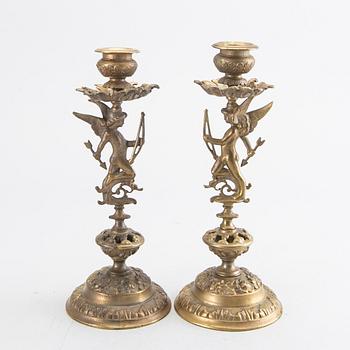 A pair of late 19th century brass candlesticks.