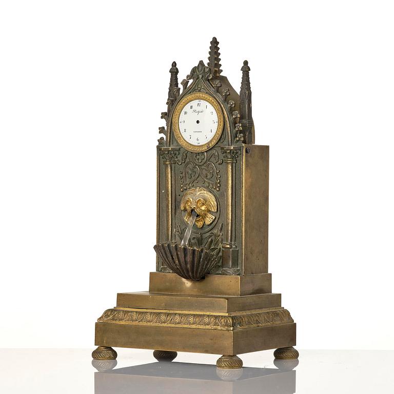 An English neo-Gothic patinated and ormolu mechanical mantel clock, ca 1820.