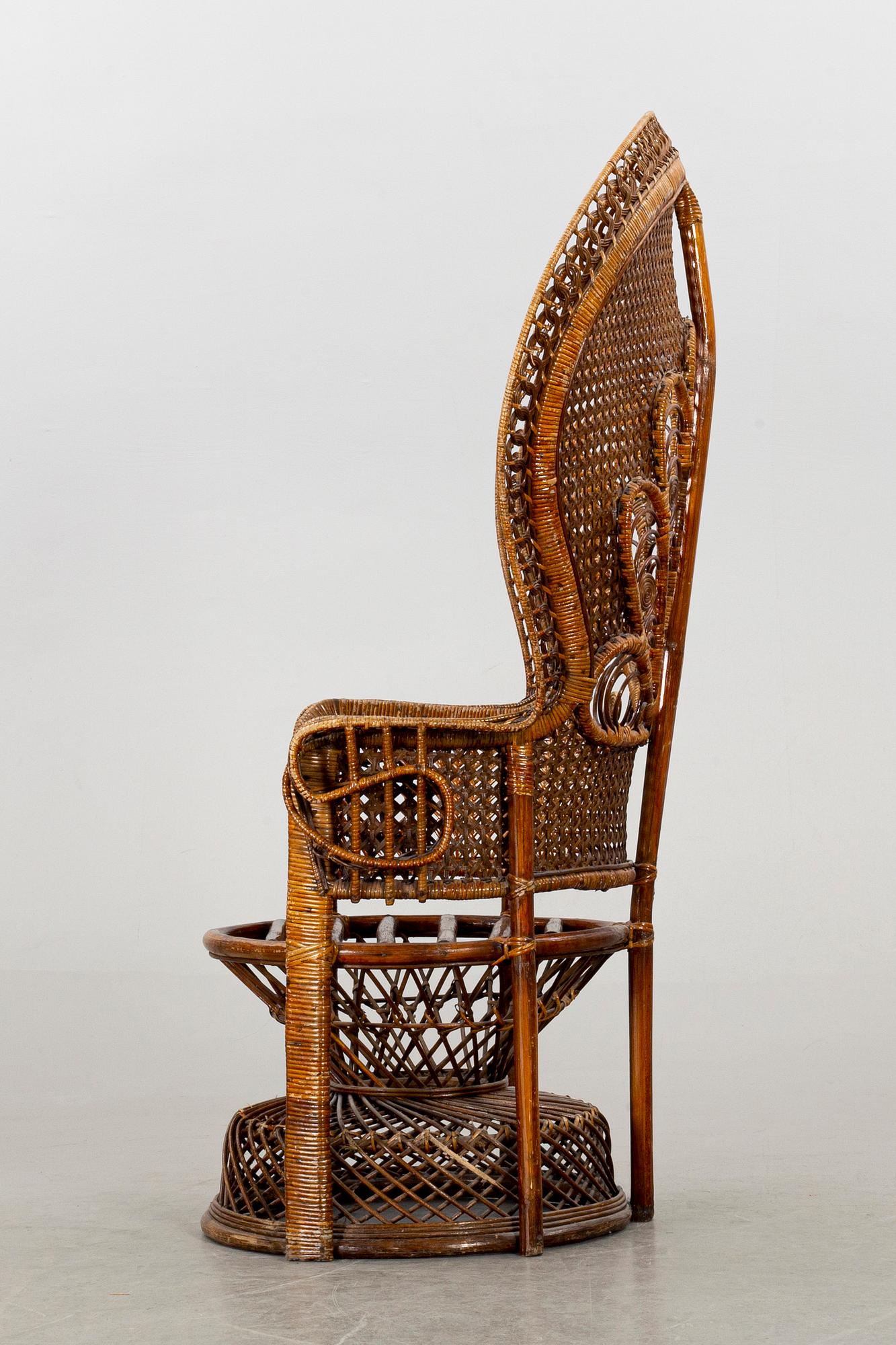 A RATTAN ARMCHAIR.