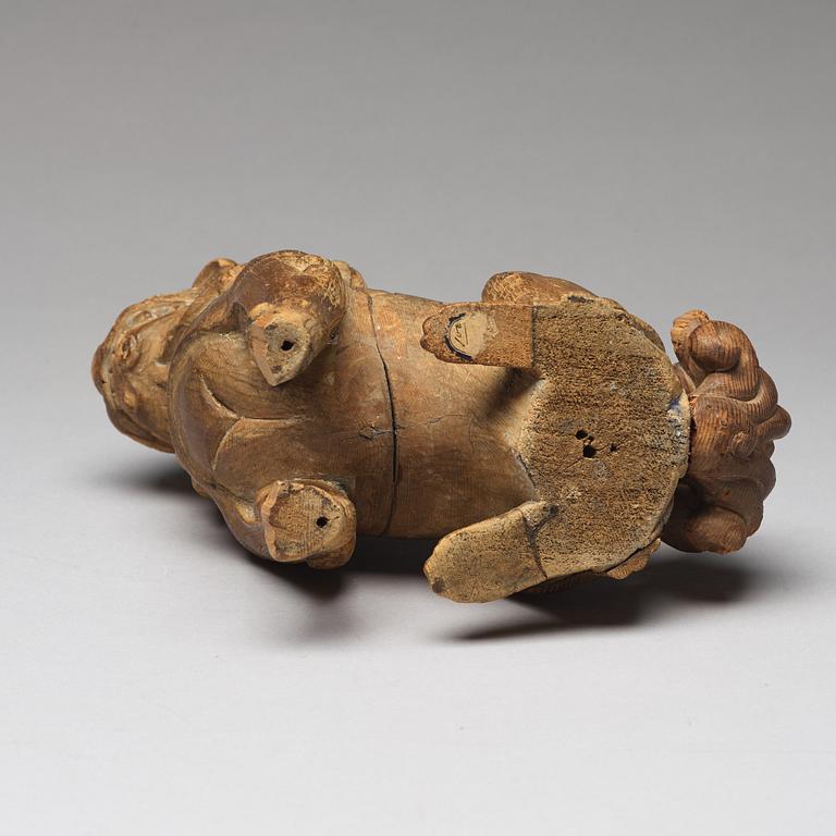 A wooden sculpture of a buddhist lion, Qing dynasty, 19th Century.