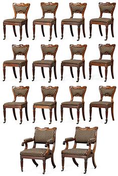 897. A set of late Regency twelve chairs and a pair of armchairs.