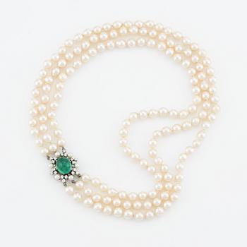 Necklace, three-strand, cultured pearls, clasp by Carlman 18K white gold with cabochon-cut emerald, pearls, and diamonds.