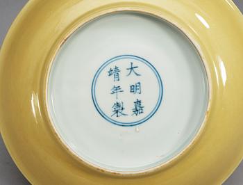 A Yellow glazed dish, Ming dynasty with Jiajings six character mark and period (1521-1567).
