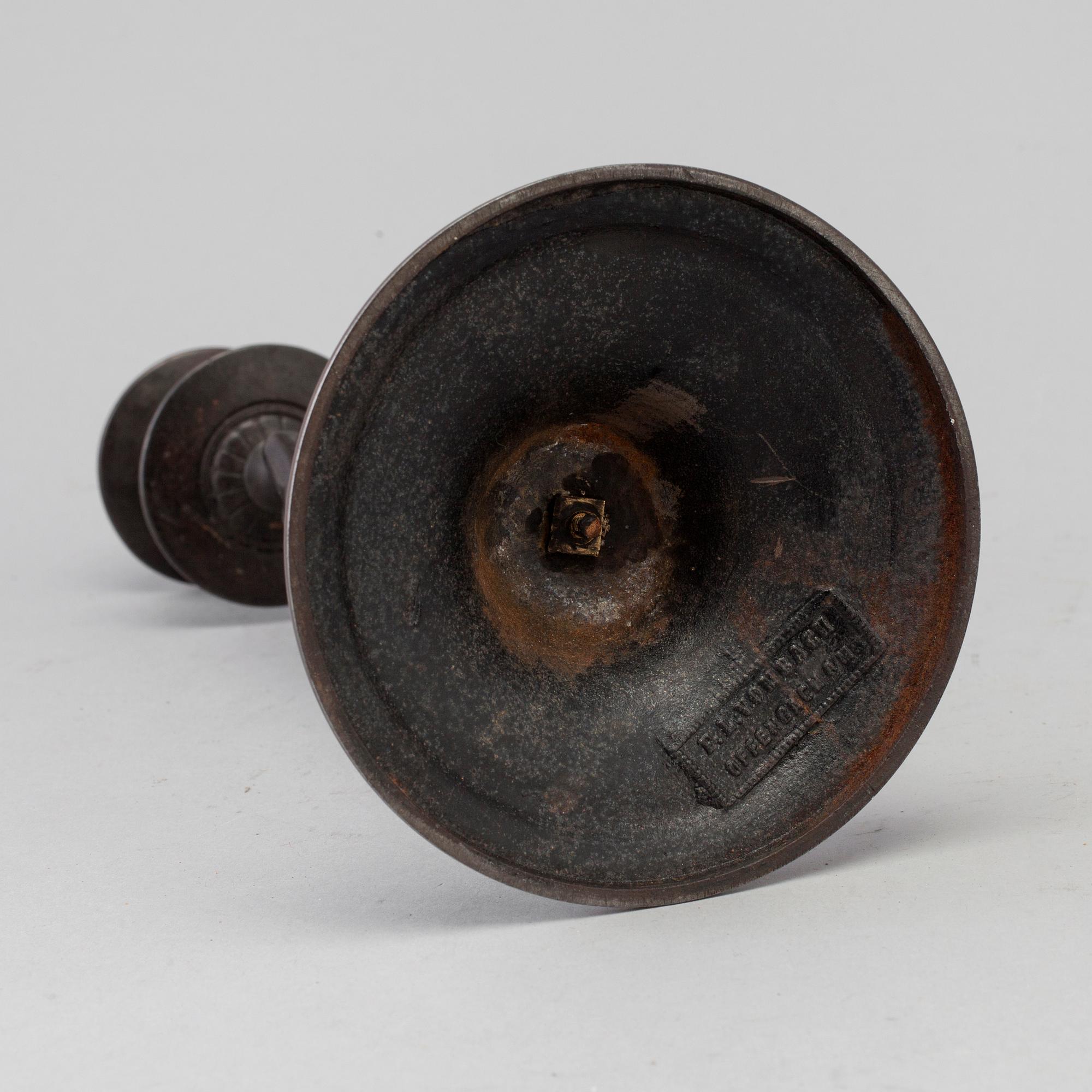 A 19th century iron candlestick marked F.L Vombach Offenbach A/M.