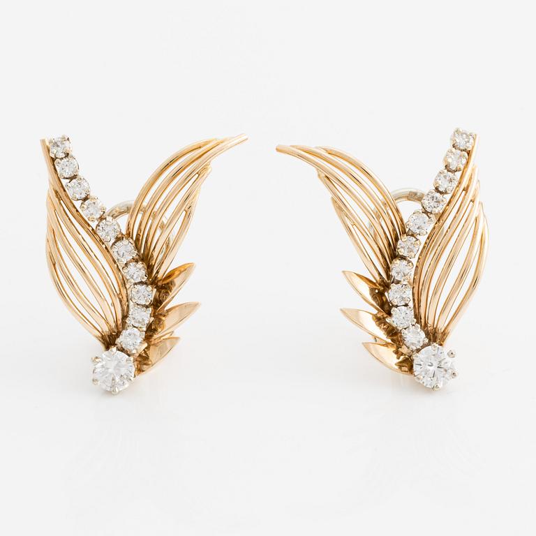 A pair of 18K gold earrings with round brilliant-cut diamonds.