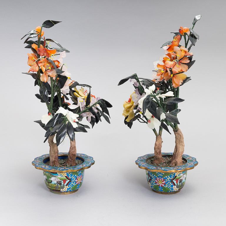 A pair of Chinese table decorations in various stones, enamelled pots. The latter half of the 20th century.