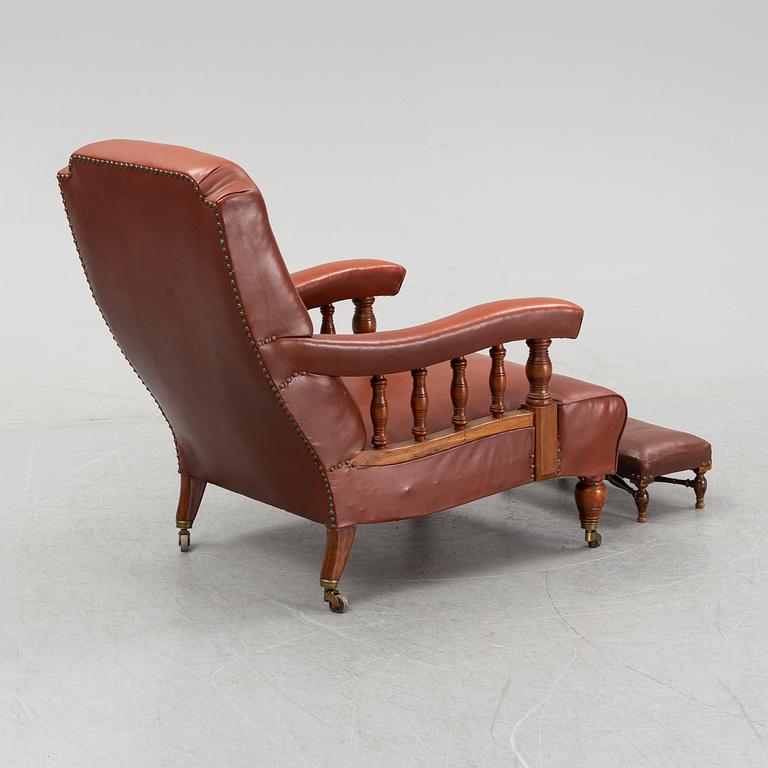 A late empire armchair with stool, mid 19th century.