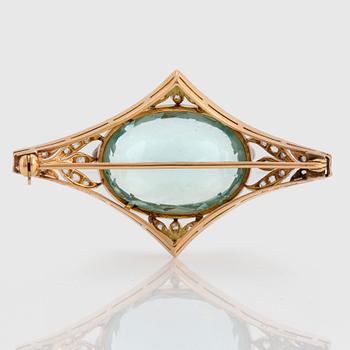 An 18K gold and platinum brooch set with a faceted aquamarine weight ca 34.00 cts.