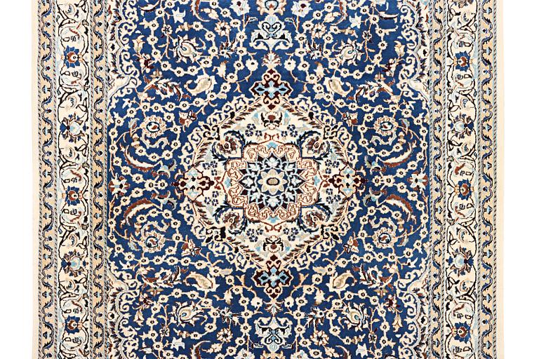 A Nain carpet, part silk, 9 laa, c. 300 x 189 cm.