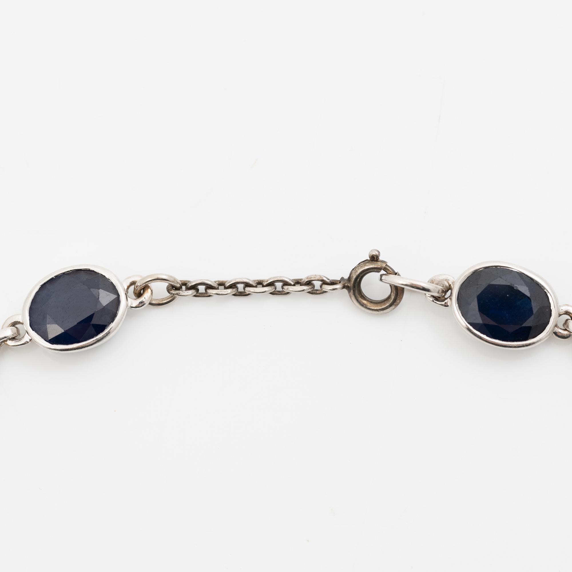 18K white gold necklace with dark sapphires.