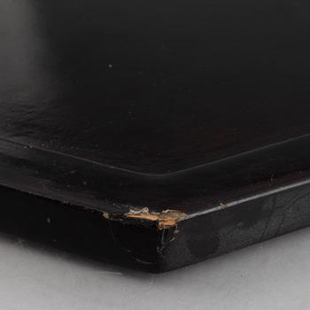 Four black-lacquered wall decorations, China, around 1900.