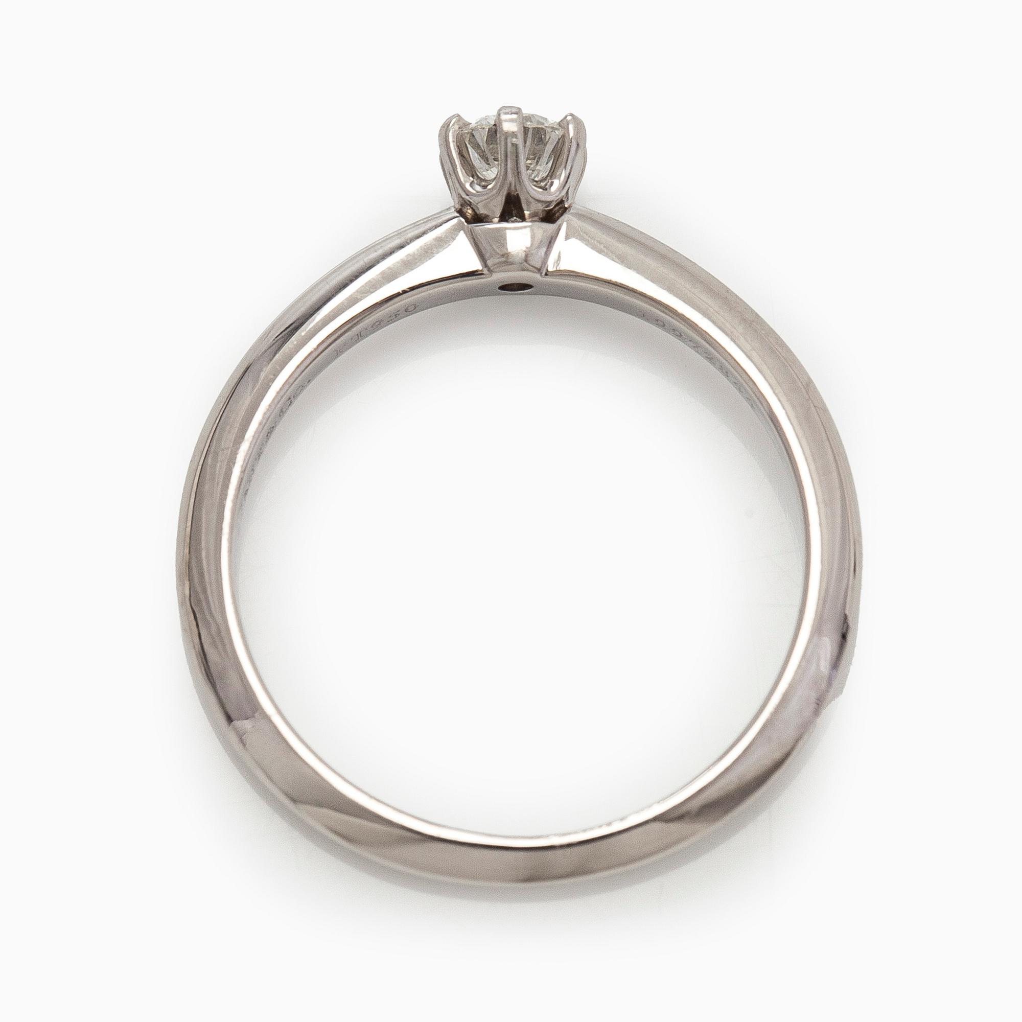 Tiffany & Co, a platinum solitaire ring with a brilliant-cut diamond.