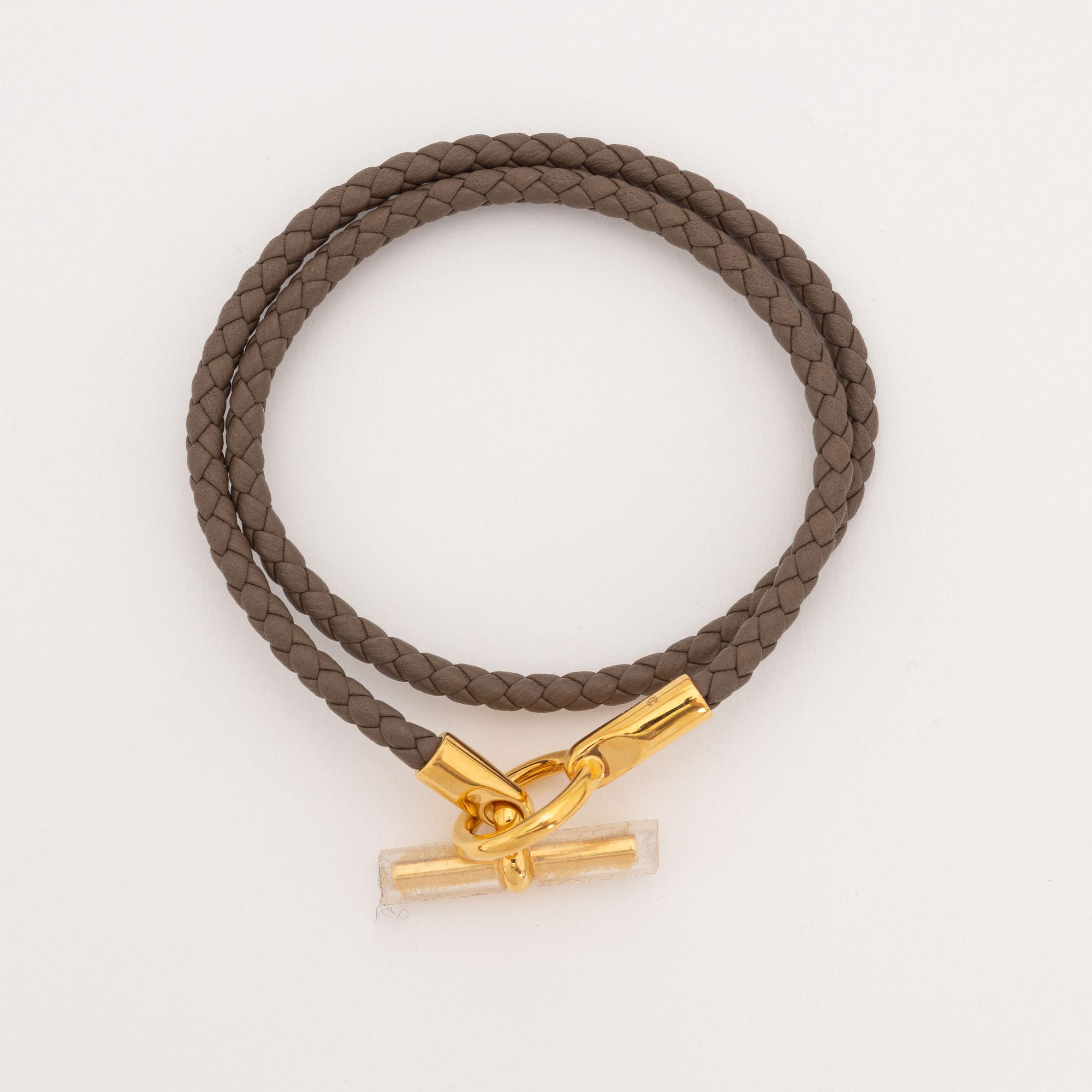Hermès, a leather bracelet and key chain.