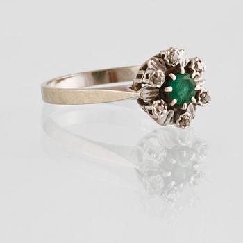 RING, 18K vitguld med 6 åttkantslipade diamanter samt en fasettslipad smaragd, importstämplad. Vikt 3,1 gram.