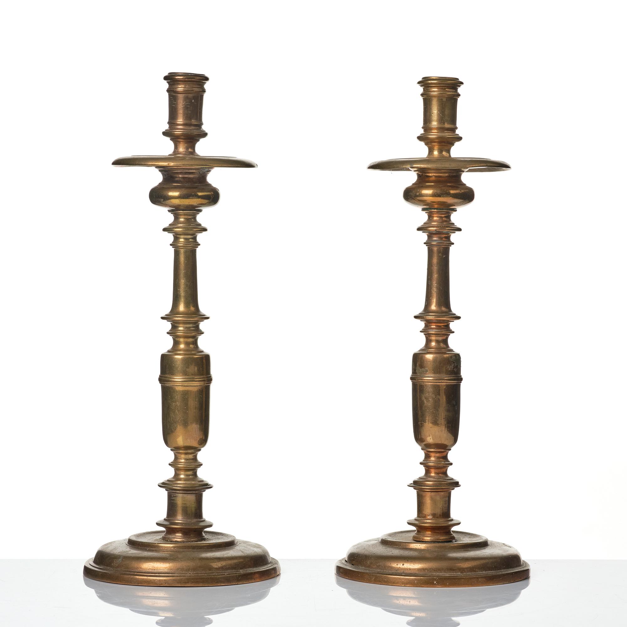 A pair of baroque brass candlesticks, 18th century.