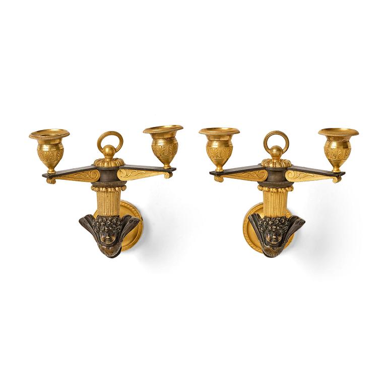 A pair of Empire patinated and ormolu two-branch appliques attr. to C. Galle (bronzier in Paris 1786-1815).
