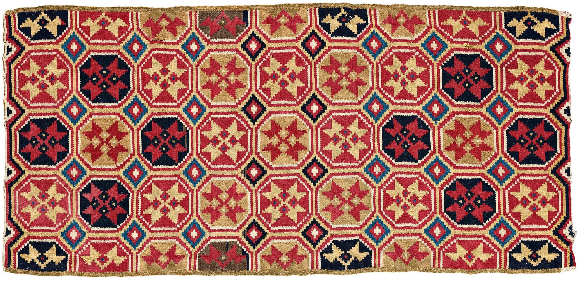 A CARRIAGE CUSHION, double-interlocked tapestry, "Stjärnmönster", ca 43,5-44,5 x 94-95 cm, Scania (Sweden).