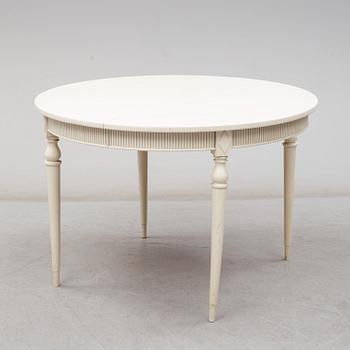 Four chairs with dinner table, late 20th Century.